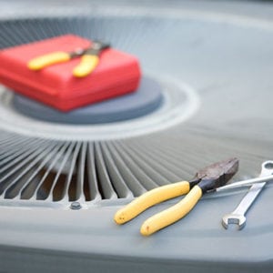 tools resting on top of air conditioning unit