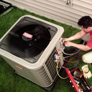 HVAC tech working on ac unit