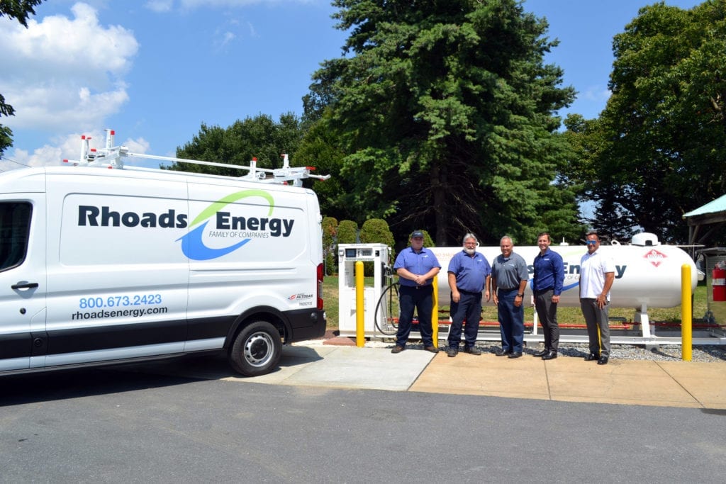 Rhoads Energy team members next to a service van. 