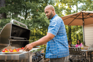 Man grilling outside on patio