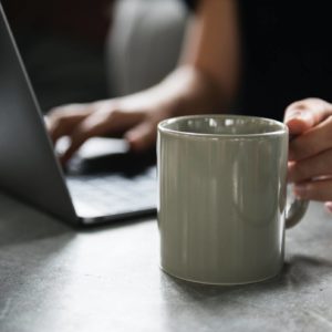 Woman with a computer and coffee mug