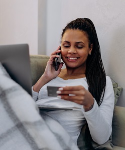 Women on the phone with a credit card in her hand